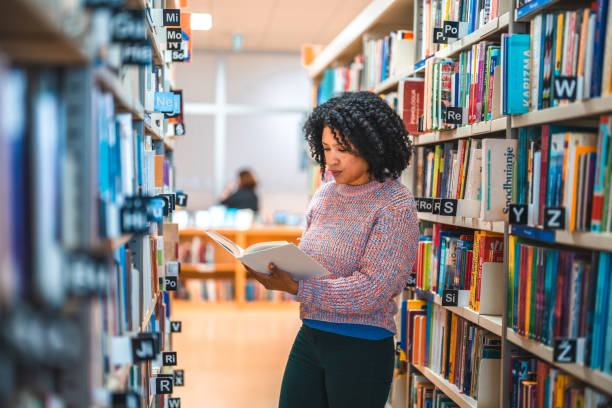 istock Hispanic Female In 30s Reading In A Library 1694509333
