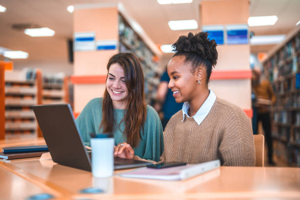 istock Caucasian Female Tutoring A Hispanic Student 1694509334