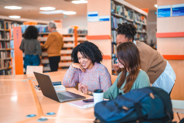 istock Diverse Females Using Laptop In A Library 1694509342
