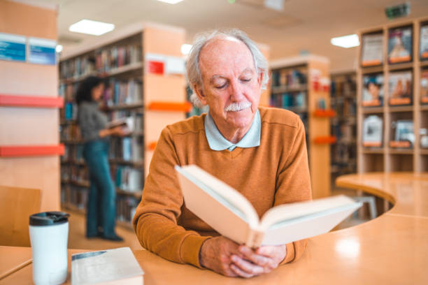istock Senior Caucasian Reading In A Library 1694509345