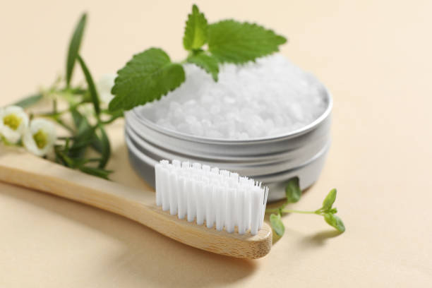 istock Toothbrush, salt and herbs on beige background, closeup. 1694518480