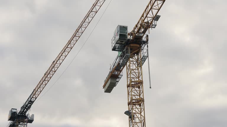 Civil engineering - tower cranes on the construction of the building