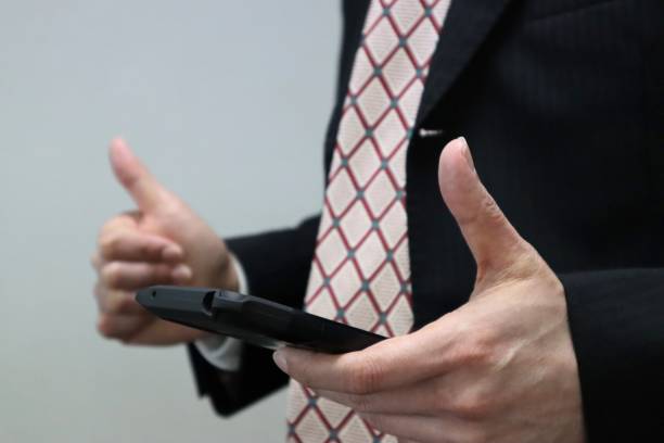 Photo of a happy businessman holding a smartphone