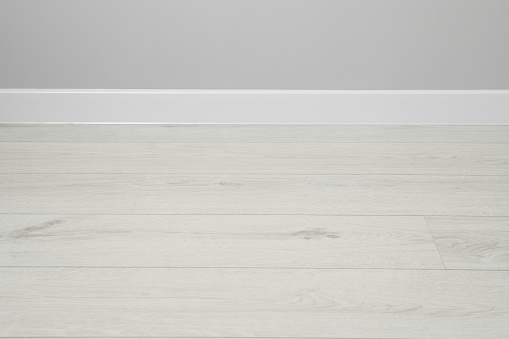 White plinth on laminated floor near wall indoors