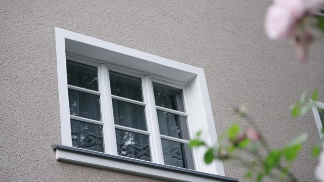 Establishment shot of traditional white windows on German building in Berlin