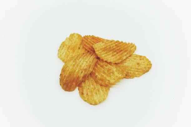 istock Textured thinly sliced potato chips snack with seasoning sprinkles 1694561808