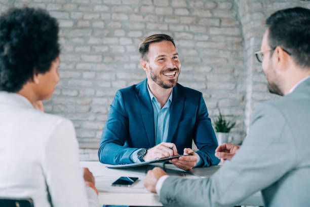 istock Group of business persons talking in the office. 1694566104