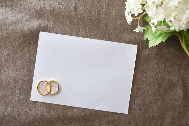 istock Note paper with rings on cloth with bouquet 1694570916