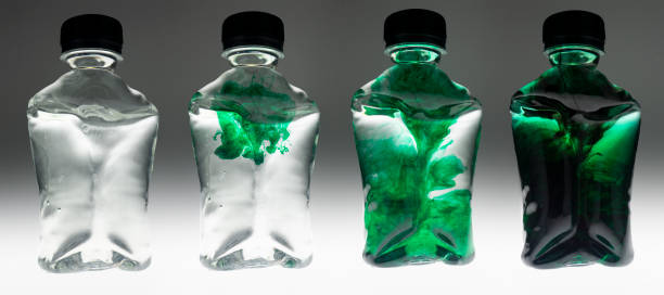 Plastic bottle containers with food colouring mixing creating unique textures and patterns Thailand Asia
