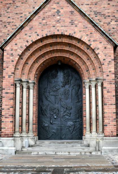 Old vintage building entrance door made of wood with metal enhancements.