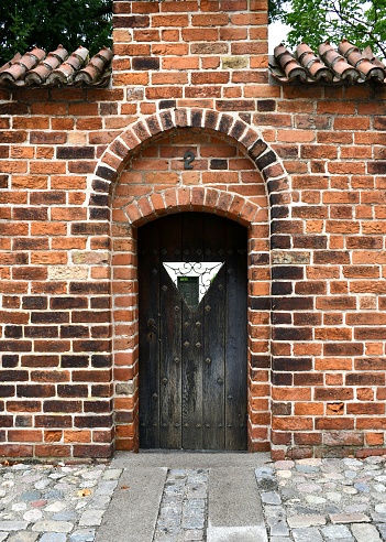 A wooden door in a brick wall