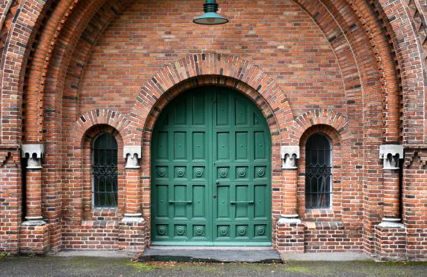 istock Teal church door with light 1694607622