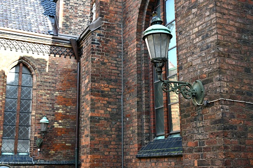A shot of a very old church in the Swedish city of Malmo and its outside lanterns