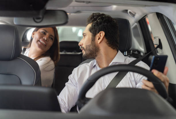 istock Crowdsourced taxi driver picking up a woman 1694629238