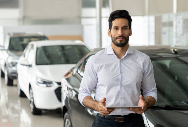 istock Salesman working at a car dealership 1694629249