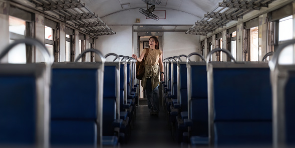 Asian woman young backpacker stand interior of the train looking for tourism. concept transport lifestyle active journey and travel adventure.