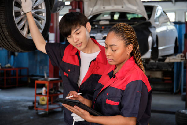 310+ Female Mechanic Inspecting A Lifted Car Stock Photos, Pictures &  Royalty-Free Images - iStock
