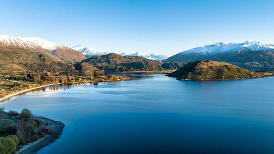 Aerial view across Glendhu Bay , Lake Wanaka towards the snow capped mountains in  Mount Aspiring National Park