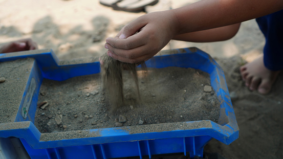 children explore their toys with soil