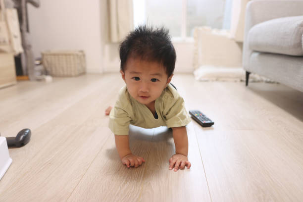 istock Curious baby boy exploring living room 1694718210
