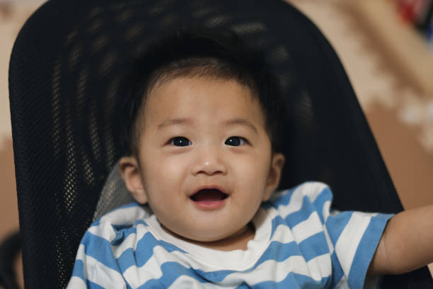 istock Curious baby boy enjoying himself 1694718240