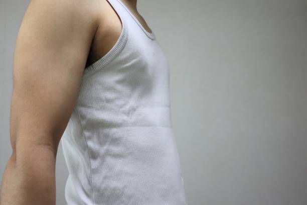 Blank white sleeveless shirt mockup, different views, 3d rendering. Empty jersey fabric undershirt for basketball workout mock up, isolated. Clear sporty basic tank top activewear template.