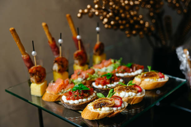 istock Canapes on a glass table. Luxury catering. 1694763342