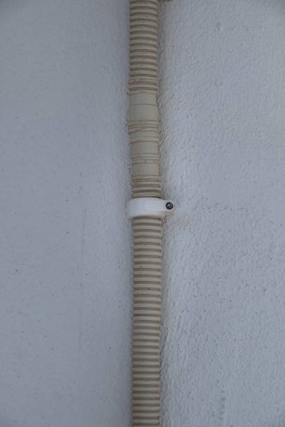 istock drain hose under air conditioner. attached to the wall. 1694793373