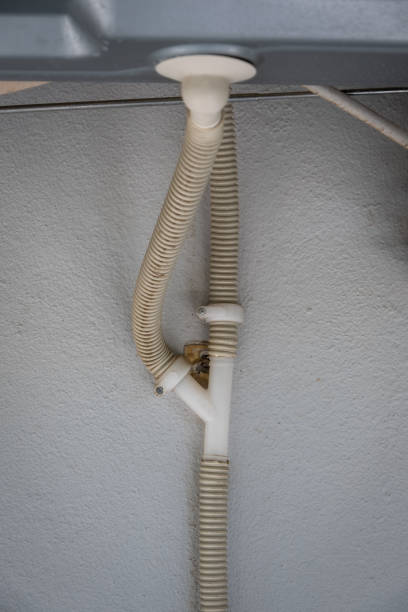 istock drain hose under air conditioner. attached to the wall. 1694793374