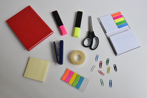 Top shot of office supplies on white background