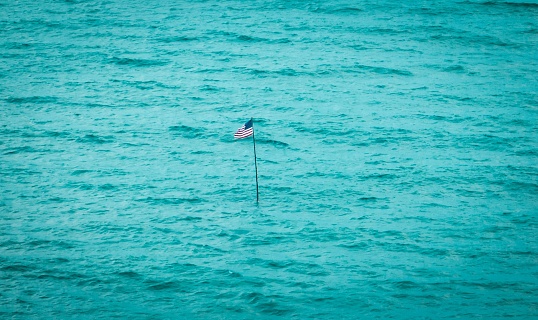 The American flag in the middle of the ocean near Vero Beach, Florida