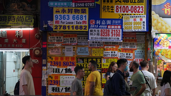 Hong Kong, September 25 2023 :advertisement for rent cover the street in Mong Kok. Rent on high-end flats remains more expensive than in any other city worldwide.