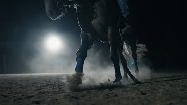 SLO MO Young Male Rancher on Horse Galloping on Sandy Ranch in Dark at Night