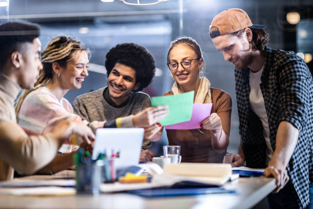 istock Team of young creative people making plans on a meeting in the office. 1694816377