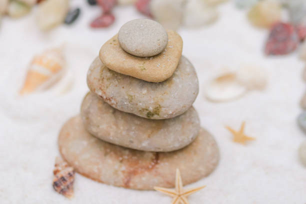 istock Balancing rocks on the beach with sand. 1694822198