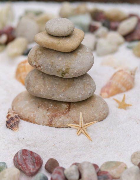 istock Balancing rocks on the beach with sand. 1694823829