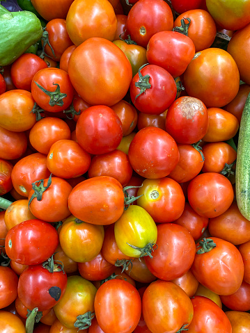 Stack of red and yellow tomatoes on market stall.  background. top view