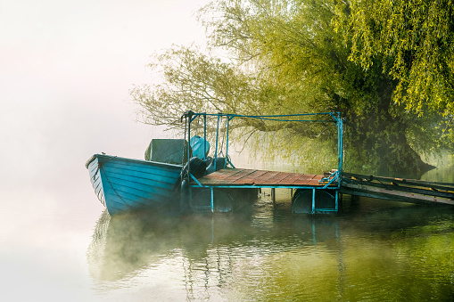 Fishing boat on river in the morning