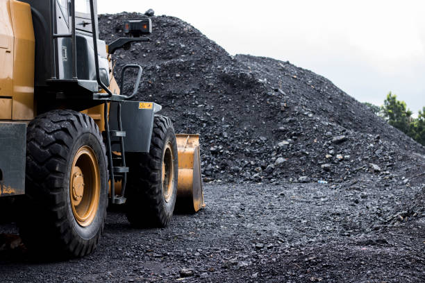 istock Construction of heavy equipment on the site on a coal dump, Excavator working in the coal storage 1694848419