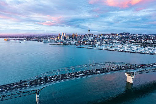 Auckland Harbour bridge with a moderate traffic and Auckland city in the background