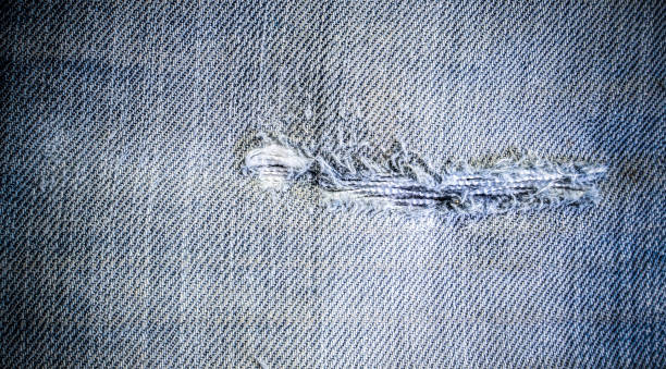 istock Torn mark and defect of denim fabric 1694858990