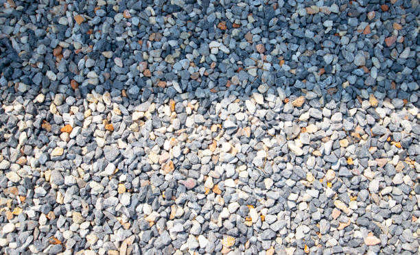 istock Light and shadow patterns on space of white, gray, black pebble wall. 1694859144