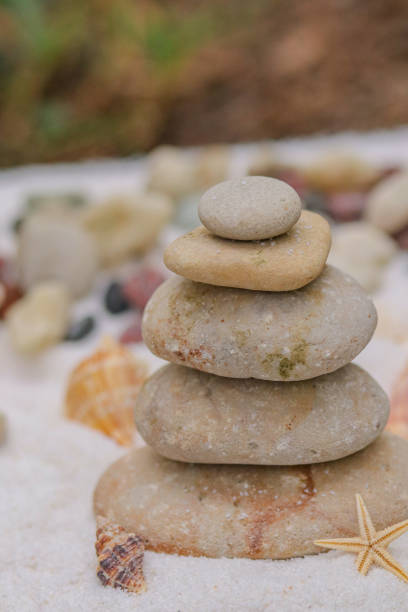 istock Balancing rocks on the beach with sand. 1694859262