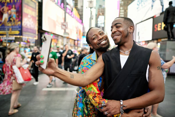 istock Black couple posing for selfie in Times Square 1694885245