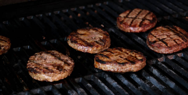 istock Hamburgers cooling on flaming grill, slow motion. Shot on Phantom Flex 4K camera. 1694899894
