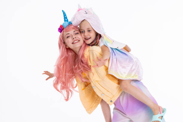 istock Shooting process vacation concept modern young mom and preschooler daughter posing in different poses in white studio isolated 1694908269
