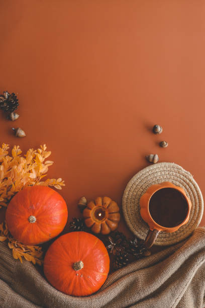 istock Autumn background top view, pumpkin and leaves on orange background 1694924372