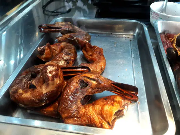 Photo of On the window of the restaurant are Hong Kong's famous roast goose, duck and pork sausages and chicken legs. Shooting through the glass