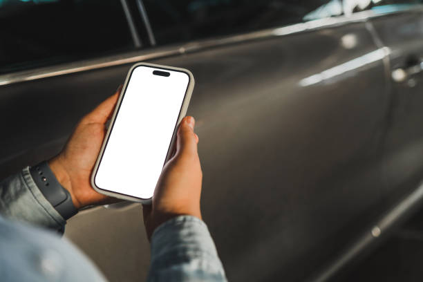 istock Phone with isolated screen on the background of a car 1694939862