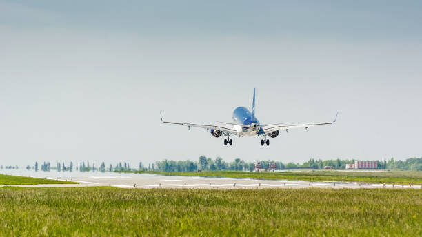 istock Passenger jet aircraft landing on a runway on a sunny day 1694939928